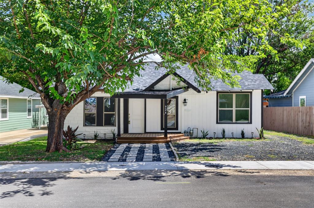 Step into a highly desirable neighborhood offering the perfect balance of vintage charm and modern comfort. This delightful 1920s bungalow, surrounded by mature trees, welcomes you with a charming front porch—ideal for relaxing and enjoying the neighborhood. Conveniently located about 10 minutes from the vibrant Bishop Arts District in Oak Cliff, you’ll enjoy easy access to a variety of restaurants, boutiques, and local shops. Take advantage of this great opportunity at an attractive price.
Inside, the home features a bright, cheerful interior that has been thoughtfully remodeled while preserving touches of its original character, including stone accents at the entrance. Modern upgrades such as hardwood floors, granite countertops, and marble tile showers blend beautifully with its historic appeal. This single-story residence offers both style and functionality, with a convenient layout where every room is within easy reach. I-35 and I-67 are approximately 5 minutes away.
The two primary bedrooms are generously sized—one with direct access to a bathroom, while the other connects to a spacious laundry room that can also serve as a pantry or additional storage area. A third bedroom offers flexibility, with access to a bathroom, the backyard, and the kitchen -perfect as a guest room, home office, or playroom. The updated kitchen, complete with new appliances, flows seamlessly into the living and dining areas, creating an inviting space for everyday living and entertaining.
Step outside to enjoy a large, fenced backyard with a covered porch, offering endless possibilities for outdoor living, gardening, or gatherings. A gated side entrance leads to an expansive rear parking area with space for up to six vehicles, providing exceptional flexibility for homeowners needing extra parking, storage, or room for work vehicles, recreational vehicles, and trailers.
Significant updates include plumbing, water heater, and roof replacement, providing added peace of mind.
