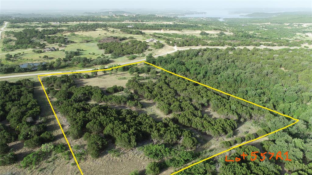TEN GORGEOUS ACRES with creek running along the west edge is ready to build at The Hills Above PK Lake! Recently brush hogged and ready to walk the property! Enjoy time on your ATV exploring the land and developing your landscape before you even build. The age-old elm tree that sits in the middle of the property is a must for showcasing when you do build on your own time frame with the choice of your builder! No manufactured homes allowed or RV's sitting out. 2500 sq ft minimum build. Enchanted Rock Court is a quiet cul-de-sac that aptly describes the unique character and features of this tranquil lot. Sights and sounds of nature are all around as well as the amazing star show above on clear nights! Additionally, even as a lot owner, you will have access to the upscale community amenities including the clubhouse, infinity swimming pool, fitness center, community lake cabin, boat dock, and watercraft launch. The quaint town of Graham is approx 20 min away. The growing town of Mineral Wells is approx 30 min away. The Trading Post store open year round is approx a 10 min drive. Summer is almost here and it is a good time to come on out and start looking at how to create family memories at gorgeous PK Lake- a short drive west of Ft Worth.