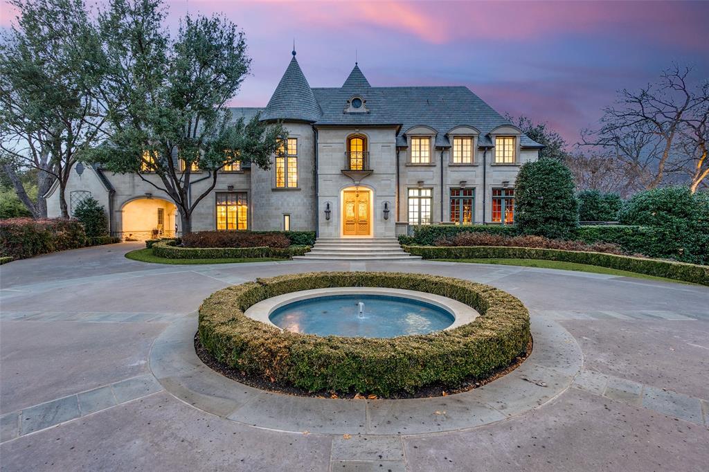 This Private French Estate with tennis court is nestled behind secure gates on two beautifully landscaped acres, offering timeless architecture, extraordinary privacy, & extensive recent upgrades. Built by Cy Barcus and designed by renowned architect Wilson Fuqua, the 11,056-square-foot residence showcases impeccable craftsmanship, grand scale, & sophisticated living. A dramatic foyer with a sweeping staircase opens to elegant formal living & dining spaces, refined archways, & a gracious family room featuring a fireplace, bar, & wine cellar. The fully renovated gourmet kitchen is equipped with new custom cabinetry, countertops, Wolf & Sub-Zero appliances, oversized island, double ovens, built-in refrigeration, & a butler’s pantry. The oversized primary suite is secluded on the main level & includes a sitting area with blackout shades, fireplace, expansive his-and-hers closets, & a completely remodeled spa bath with designer finishes. Upstairs offers four spacious ensuite bedrooms plus a large game room & kitchen. Designed for effortless entertaining, the home features exceptional indoor-outdoor flow to a resort-style backyard with pool, outdoor kitchen, covered living areas, cabana, & tennis court. Extensive Improvements & Features Include: RTI smart home system; Lutron lighting; designer tile by Ann Sacks, Walker Zanger, & Artistic Tile; updated bar, family room, study, dining room (with hand-painted Allan Knight wallpaper); new mini kitchen upstairs; new water filtration system, thermostats, sewer line, chimney cap; three-car garage with EV charging in each bay; Complete wood, iron, & chain-link perimeter fencing for maximum security; Expanded drive & improved motor court & porte cochère; Renovated fountain with bluestone surround & new pool walkway, & MORE! A rare opportunity to own an updated, architecturally significant estate offering privacy, scale, & luxury amenities in a premier Dallas location. Conveniently located near the private school corridor!