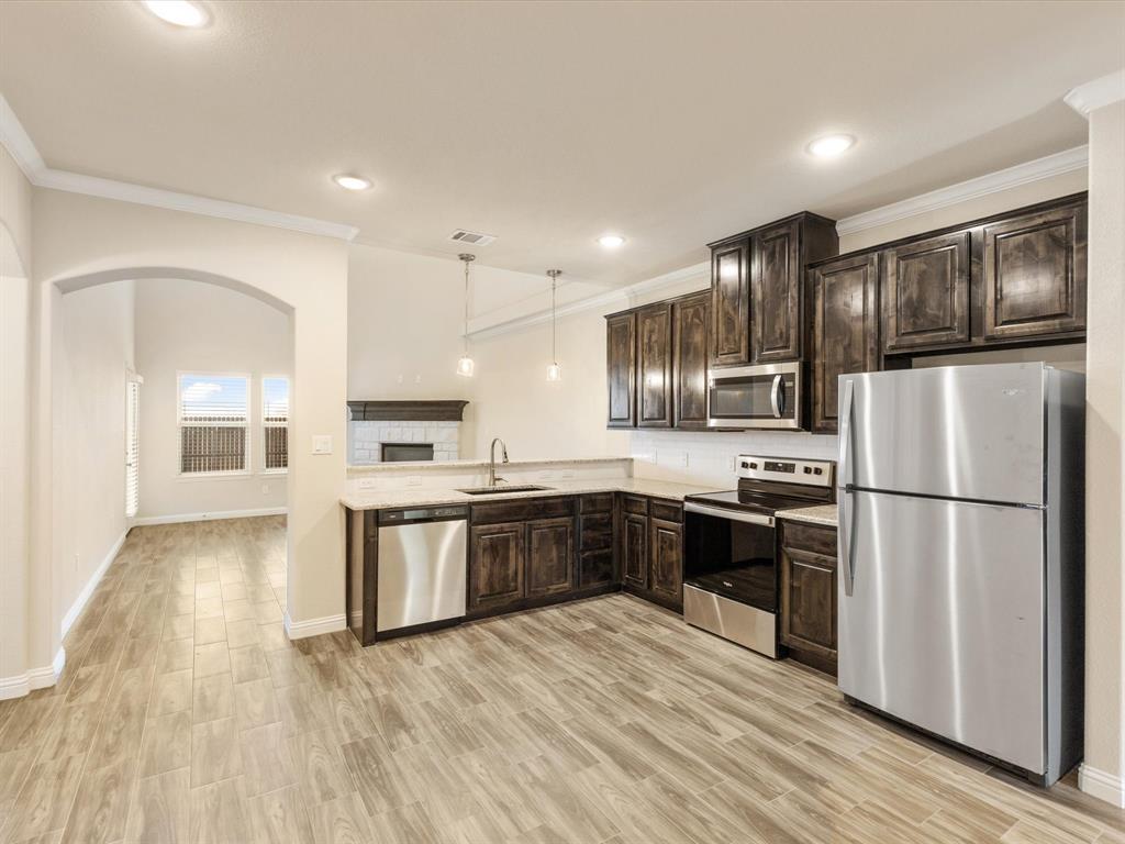 Seller offering $5000 with acceptable offer to go towards closing costs or rate buy down. Conveniently located just off Hwy 377, this energy efficient townhome has all you could need and more. Kitchen features granite counter tops, high top bar, stainless steel appliances, including Whirlpool refrigerator and walk in pantry. Separate in unit laundry area with storage closet and hanging space. The primary bedroom is large enough for a  king bed. Ample bathroom storage and granite counter tops in the en suite bathroom. Half bath located downstairs for guest. Upstairs are two over sized guest rooms, each with a large walk in closet. Jack in Jill bath and large bonus area that could be used for an office, play room, exercise equipment, etc. Conveniently access the attic at the top of the stairs for additional storage. Outside is a small covered patio and private yard separated by person 6ft privacy fence. Attached 2 car garage. Fully sodded and irrigated from and back yard. Yard maintenance is included in monthly HOA dues. Easy access to 377 and now Fall Creek Hwy. Acton ISD schools. Great for a personal residence or investment!