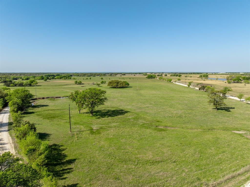 Discover the beauty of Texas Countryside full of lush, green pastureland ready for your homestead or residential improvement. This picturesque property with its rolling terrain showcases open spaces with mature shady trees and breathtaking views. This property has it all for farming, ranching, recreation, and development with over 1k feet of road frontage and the potential for additional meters. Bring your cattle or horses as the infrastructure for livestock is in place with full perimeter fencing, 2 stock tanks, and a barn with a working pen. With no known deed restrictions and several elevated building sites, this property would be suitable for multiple families looking to create a lifestyle together. Cheap taxes as ag exemptions are in place! Located just a short distance to the shores of beautiful lake Whitney!