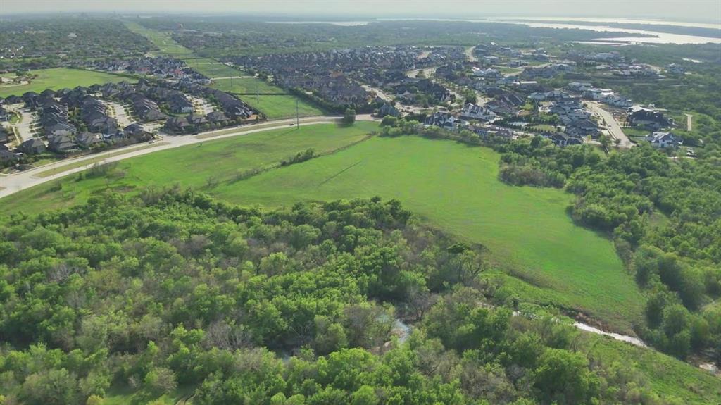 An exceptional opportunity to secure your place in Frisco's newest luxury gated community, Kingswood Creeks. Lot 13 offers 7,487 square feet and backs to approximately 6 acres of private greenbelt, mature trees, and a serene creek, creating a rare combination of privacy and natural beauty. Currently under development, this exclusive enclave will feature just 52 custom estates in the heart of Frisco's prestigious Stonebriar District. Tucked away at the end of Rock Creek Parkway, the community provides a secluded setting while remaining just minutes from The Star, Legacy West, premier dining, shopping, and entertainment. Purchase now at pre-sale pricing and begin designing your dream custom home for construction in 2027. The lot accommodates a spacious floor plan, with potential for a 4,000+ square-foot single-story residence or a 7,000+ square-foot two-story estate. Additional benefits include side-entry garage access and side-entry trash service for enhanced curb appeal. As Frisco's luxury market continues to thrive, Kingswood Creeks presents a unique opportunity to invest in one of North Texas' most sought-after locations while creating a truly custom living experience.