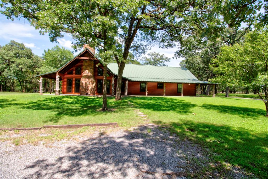 Welcome to your private Texas oasis! Nestled outside city limits with no HOA, this stunning, custom built log cabin offers the ultimate blend of rustic charm and modern freedom. Situated on a sprawling 3.817 acres of small acreage, this single owner gem is a rare find in today’s market.
Boasting 2,695 sq. ft. of beautifully designed living space, the home welcomes you with an abundance of natural light, soaring ceilings, and rich wood finishes that only a true log home can provide. The open-concept layout is perfect for family gatherings or entertaining friends.
Step outside to experience true country living. The iconic wrap around porch offers the perfect spot for morning coffee or watching spectacular Texas sunsets. The expansive property features an aerobic septic system, an attached carport for convenient vehicle shelter, and plenty of room to roam, garden, or bring your animals. A standout feature of this property is the detached shop ideal for hobbies, a home business, equipment storage, or the ultimate man cave workshop. Located in the Collinsville area, you get the peace and privacy of rural county living while staying just a short drive from local schools, shopping, and dining. Don't miss this incredible opportunity to own a piece of Texas paradise!
