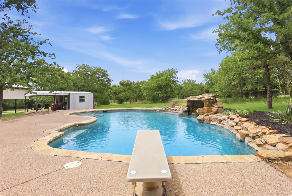 Escape to your own slice of Texas, swim in your DIVING POOL, enjoy paradise on 5 cross-fenced acres in Bridgeport! This 4 bedroom, 1.5 bathroom home offers the perfect blend of country privacy, completely updated and functionality with open-concept living, two spacious living areas with a media or game room, and a cozy wood-burning stove that anchors the heart of the home! 

Step outside and the property unfolds like a backyard retreat featuring a deep diving pool with a stunning rock grotto, this space was made for unforgettable summers. The workshop with covered patio provides endless possibilities for hobbies, entertaining, or extra workspace, while the 4-car metal carport with storage gives you room for all the vehicles, toys, tools, and equipment.

Whether you’re looking for peaceful country living, room to roam, or the ultimate place to entertain, this property delivers privacy, charm, and versatility all in one package.