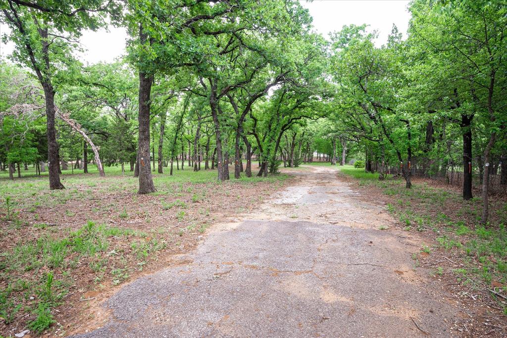 Nestled in the heart of Keller, this exceptional, heavily treed property offers a rare and versatile opportunity to create something truly special. Whether you envision building a private estate or developing multiple homesites, this property provides the flexibility to bring your vision to life.

Set among a canopy of mature trees, the land offers a peaceful, park-like setting with a sense of privacy that is increasingly hard to find. The property can be enjoyed as one expansive estate of approximately 2.803 acres or has already been thoughtfully planned for subdivision into three generous homesites—each offering ample space, beautiful natural surroundings, and the potential for stunning custom homes.

Tucked away on a quiet, proposed cul-de-sac, the layout allows for both exclusivity and functionality, making it ideal for a single luxury residence, a family compound, or a boutique development opportunity. Expansive building areas provide room for outdoor living, pools, and more—all while preserving the character and beauty of the existing trees. 

Enjoy the best of both worlds with a serene, secluded setting just minutes from top-rated schools, shopping, dining, and everything Keller has to offer. Opportunities like this—offering both privacy and flexibility in such a prime location—are truly rare.
Bring your builder, your vision, and your dreams—this is where they can all come together.