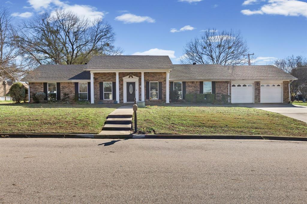 Welcome home to this beautiful brick residence located on a spacious corner lot, offering room to grow and play. This thoughtfully designed 3-bedroom, 2.5-bath home features an open-concept layout that brings everyone together, with a generous dining area flowing into the cozy family room and kitchen. The family room is highlighted by vaulted ceilings and a gas fireplace with built-in cabinets, creating the perfect space for entertaining or relaxing evenings at home. The bright kitchen features modern white cabinetry, tile counter tops, and plenty of space for cooking and gathering. A private utility room with abundant built-in storage helps keep everyday life organized and clutter-free. There is even a designated area for an office for those working from home. 3 spacious bedrooms provide comfortable retreats for every member of the household. Enjoy outdoor living with covered front and back patios—ideal for morning coffee, weekend grilling, or watching kids and pets play in the fenced backyard. A storage shed adds extra space for bikes, toys, or gardening tools.With a 2-car garage, ample storage throughout, and a welcoming layout designed for everyday living, this home offers comfort, functionality, and a setting that’s easy to love. Close to stores, restaurants and easy access to I30.  You don't want to miss your opportunity to call this house your home!