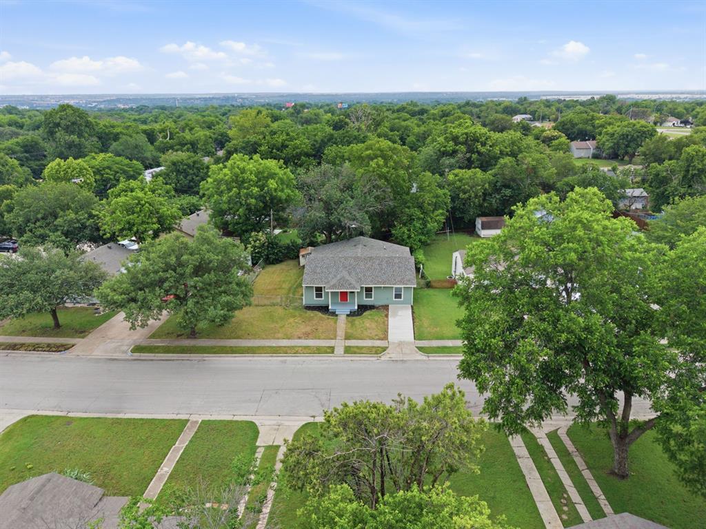 Completely reimagined from top to bottom, 7107 Garza Ave brings the kind of modern finishes and oversized primary suite buyers are obsessing over right now. Inside you’ll find an open layout with new LVP flooring, designer touches, updated lighting, quartz countertops, custom cabinetry, and beautifully renovated bathrooms throughout. The primary suite is the standout feature of this home, offering THREE closets and a jaw-dropping spa-style bathroom with a freestanding soaking tub, oversized walk-in shower, dual vanities, and floor-to-ceiling tile work that feels straight out of a custom luxury build. Big-ticket upgrades include a new roof, new windows, new siding, and updated electrical panel, giving buyers both style and peace of mind. Sitting on a spacious lot with mature trees and great curb appeal, this home is move-in ready and conveniently located near downtown Fort Worth.