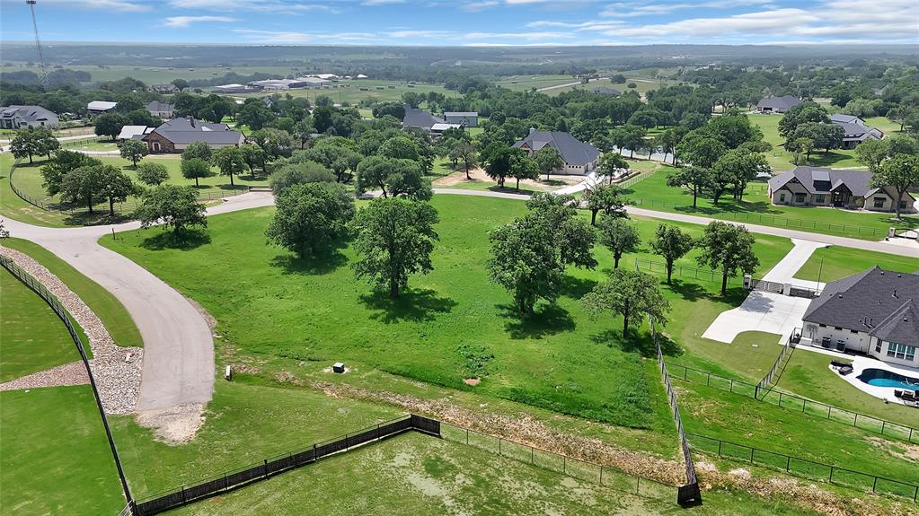 301 Pidgeon Lane offers a rare opportunity to own a beautiful 2-acre corner homesite int he highly sought-after Bar H Ranche community in Weatherford, Texas. Surrounded by stunning mature oak trees, this property provides the perfect blend of privacy, natural beauty, and peaceful country living. 
With no required timeline to build and the flexibility to bring your own builder, you can create the custom home you've always envisioned while enjoying the space and serenity this property offers. Bar H Ranche features a gated entrance, underground utilities, and access to AT&T fiber optics, combining modern convenience with a scenic ranch-style setting. 
Conveniently located just minutes from Weatherford High School, shopping, restaurants, and everyday amenities, this property offers the best of both worlds- quiet living and quick access to town. Whether you're looking to build your forever home or invest in one of Weatherford's premier communities, 301 Pidgeon Lane is a property you won't want to miss!