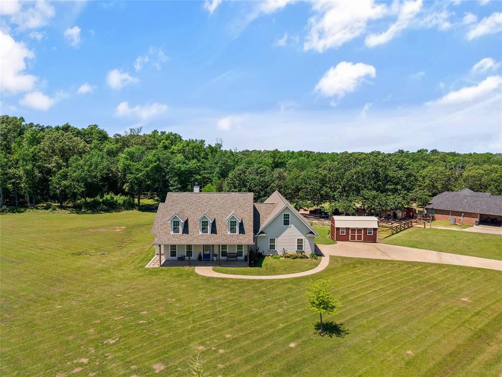 Welcome to this beautifully designed farmhouse-style home situated on 1.8 acres in the sought-after Spring Creek Addition. This 3-bedroom, 2-bath home offers nearly 2,000 square feet of comfortable, single-level living with a perfect blend of rustic charm and modern features.

Inside, you’ll find an inviting open-concept layout with a vaulted ceiling and cozy wood-burning fireplace, ideal for relaxing or entertaining. The kitchen flows seamlessly into a bright breakfast area filled with natural light from surrounding windows.

The spacious primary suite features a sliding barn door, double vanity, soaking tub, separate shower, and two separate closets, creating a private retreat. A versatile flex room provides options for a home office, dining room, or additional living space.

Step outside to enjoy peaceful country living with a covered front porch, large back deck, and fenced acreage—perfect for pets, gatherings, or simply enjoying the outdoors.

Located just minutes from downtown Emory with convenient access to major highways, this home offers the ideal balance of privacy and accessibility.