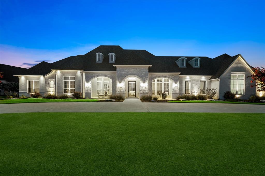Nestled in the exclusive Stinson Highlands neighborhood and served by highly sought-after Lovejoy ISD, this one-of-a-kind, single-story custom estate sits on 2.5 picturesque acres and offers a rare blend of refined luxury, privacy, natural beauty, and everyday comfort. Enjoy quiet, serene views from the private covered patio while dining al fresco or sipping morning coffee overlooking two ponds with fountains, a wooded creek, greenbelt views, and abundant wildlife.  Inside, rich hardwood flooring, soaring ceilings, and expansive windows create a bright, inviting atmosphere. The stunning great room serves as the heart of the home with a vaulted ceiling, elegant chandelier, electronic fireplace, and seamless views of the covered patio, resort-style pool, greenbelt, and ponds. Designed for entertaining and everyday living, the chef’s kitchen with quartzite countertops, premium Thermador appliances, large island, custom cabinetry, pass-through hutch to the dining room, and a separate prep kitchen with additional refrigerator, dishwasher, sink, storage, and pantry space.  The luxurious primary suite captures tranquil backyard and water views and features a spa-inspired bath with dual vanities, soaking tub, oversized walk-in shower, bidet, and custom closet with built-in dresser. A secondary primary suite provides excellent flexibility for guests, extended family, or multigenerational living. Outdoor living is exceptional with a 34-foot pool, tanning ledge, raised spa, enclosed outdoor shower, and expansive covered patio with multiple seating areas, natural gas grill, beverage refrigerator, TV area, and outdoor audio. Additional highlights include a private study, formal dining, game room, xtra storage, whole-house Generac generator, monitored network, gigabit inet, security system, ext. cameras, Ring doorbell, remote-controlled roller shades, and Ethernet-connected entertainment systems. A truly special property in one of North Texas’ most desirable school districts.