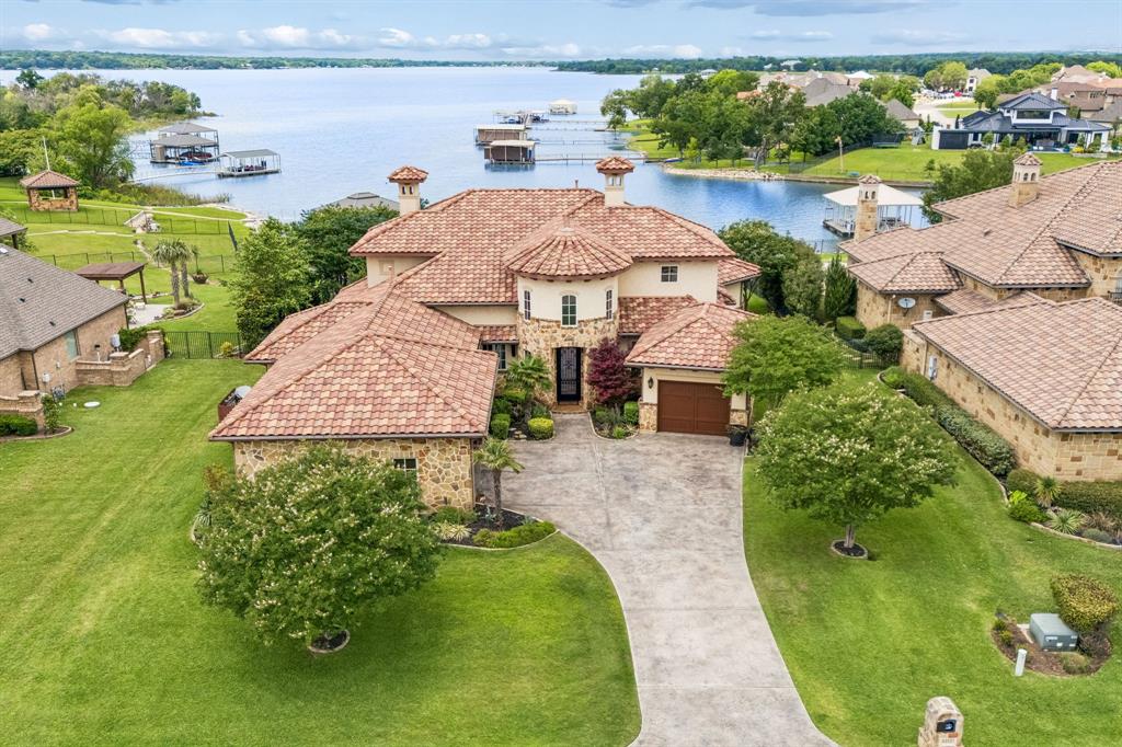 Welcome to 6212 Lakeside—an exceptional waterfront retreat on the shores of Eagle Mountain Lake with 110 feet of private waterfront and breathtaking lake views. Designed for both luxury and comfort, this home offers refined lakeside living in one of Fort Worth’s most desirable communities.

Inside, expansive windows fill the home with natural light while showcasing the beauty of the water beyond. Elegant hand-troweled walls add custom character and craftsmanship throughout the interior. The thoughtfully designed floor plan creates a seamless flow between living, dining, and entertaining spaces, all centered around the stunning waterfront setting. Step outside to a premier outdoor living area, refined with a built-in kitchen and fireplace, designed to harmonize perfectly with the home's artisan interior and panoramic views.Enjoy true open-water lakefront living with a private deep-water dock featuring a hydraulic boat lift and two jet ski slips — perfectly positioned directly on the main body of the lake, not a canal or shallow cove, providing exceptional access for boating, watersports, and year-round lake enjoyment.

Built with efficiency in mind, the home features foam insulation and radiant barrier construction, providing enhanced comfort and energy savings year-round.  

Step outside to experience true resort-style living. Whether enjoying peaceful mornings by the water, sunset gatherings, boating, fishing, or paddleboarding, this property offers direct access to the lake lifestyle buyers dream about.

The amenity-rich community includes 2 resort-style pools, a private beach, pickleball and basketball courts, an 18-hole golf course, clubhouse, fitness center, and parks, creating a lifestyle that feels like a private resort every day.

Conveniently located in Fort Worth’s sought-after 76179 area, this rare waterfront opportunity combines luxury, recreation, and tranquility in one unforgettable property.

6212 Lakeside Drive is a waterfront lifestyle.