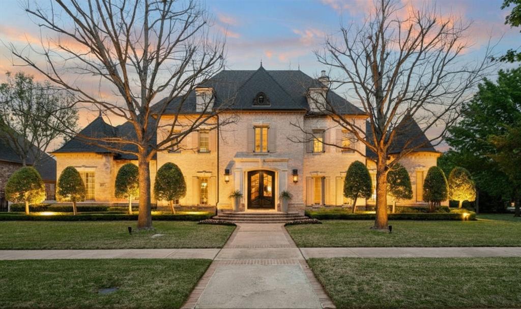 Don’t miss this exceptional home in sought-after Westmont, ideally located next to a green space for added privacy. Step inside to soaring ceilings, a stunning spiral staircase & hardwood floors throughout. The home features a well-appointed executive office accented by elegant French doors, a generous closet, cabinet storage & built in shelving. The striking rotunda provides an ideal setting for a conference table & is surrounded by windows that flood the space with natural light. Thoughtfully designed for hosting, the home features Control4 and Sonos control systems & a dedicated lounge with an integrated self-service wine station & kegerator. The inviting living room with a decorative fireplace opens to a dramatic two-story, chef-caliber kitchen complemented by a Juliet balcony overlooking the space. Features include premium Sub Zero & Thermador appliances, Taj Mahal quartzite countertops, a gas cooktop, extensive built-in cabinets & counter space. Beyond the kitchen is the mud room featuring a built-in desk and a dedicated custom cabinet for gift wrapping & craft organization. The primary suite is conveniently located on the main level & features a Hollywood tub, a huge walk-in closet with built-in storage & a custom shoe wall with 124 shoe bin capacity. A guest suite is also conveniently located downstairs with access to the covered patio. Upstairs you’ll find three bedrooms, each with its own ensuite bathroom & highlighted by walk-in closets. A spacious game room features a wet bar that flows to the media room. Two of the upstairs bedrooms are connected by a versatile flex space with built-in desks & cabinetry, perfect for studying or additional office spaces. Step outside to your private backyard oasis, highlighted by a sparkling pool with a spa & water feature. The well-appointed outdoor kitchen & living area provides endless entertainment featuring an outdoor fireplace & ample space.