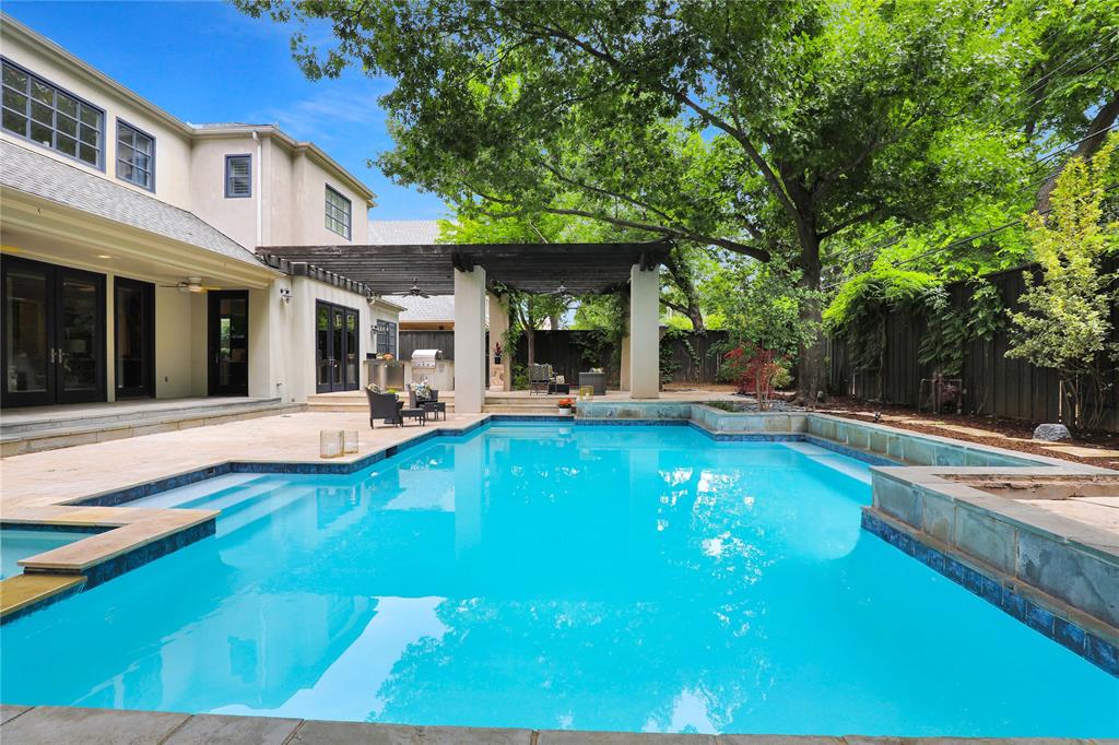 This rare luxury estate, located in the heart of the prestigious Preston Hollow, Pemberton neighborhood, seamlessly blends contemporary details with unparalleled design, in a highly sought after Dallas location. This spacious two-story home has an open floor plan, an en suite bathroom for every bedroom, and a resort-style, private backyard with an entertainer’s swimming pool, spa, outdoor kitchen and living. Gather your family in the gourmet kitchen that features a double island, custom cabinets, carrera marble counters that carry up the backsplash, and state of the art appliances. End a hard day in the expansive and tranquil primary suite. Additional amenities of the home include a second primary or Au Pair suite, a second, upstairs laundry room, and a game room with a wet bar, ice maker, and refrigerator. A perfect Fairway location, just minutes from the exceptional restaurants and shops in uptown, as well as downtown Dallas.
