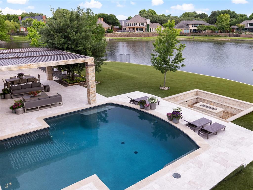 Discover modern waterfront luxury in this rare half-acre estate within the prestigious Willow Bend Lakes. Recently renovated from floor to ceiling, this soft-contemporary masterpiece offers breathtaking water views and sightings of local wildlife from nearly every room through custom iron-and-glass windows.

The interior is a study in sophisticated design, featuring wide-plank oak flooring, designer lighting, and custom rift-sawn oak cabinetry. The chef’s kitchen is anchored by a professional Wolf 6-burner gas range and integrated 48” refrigerator. A hidden, oversized pantry acts as a secondary catering kitchen, equipped with two additional ovens, a second 48” refrigerator, a second dishwasher, and floor-to-ceiling storage with a library ladder. The primary wing is a private sanctuary, boasting an elegantly curved staircase that leads to a secluded loft and balcony. The spa-inspired primary bath features a jetted tub, dual-head shower, and a room-sized custom closet. The backyard defines resort living, featuring a $250k commercial louvre system that spans 2,000 sq ft of covered outdoor space at the touch of a button. Amenities include a pool, spa, sunken firepit, heaters, outdoor kitchen, and a fully turfed yard. Tech-forward features include a Tesla charger in the 3-car garage, integrated security cameras, and a full sound system. Perfectly located near the DNT, 121, and Legacy West.