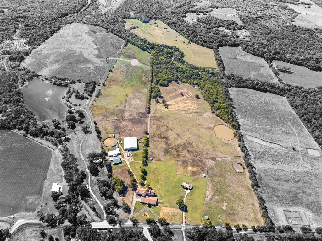 Welcome to your 139+- acre horse ranch, where Italian-inspired elegance meets Texas charm. The estate boasts 14,641 sq ft of living space, including 10 bedrooms, 10 full baths, and 2 half baths across the main house and two attached apartments. Anchored by a 52-foot limestone tower straight out of a fairytale, this property is surrounded by breathtaking rolling pastures and lush landscapes. Inside, over 120+ imported handmade Murano crystal chandeliers and sconces from Italy add a regal touch, while marble floors and ensuite bathrooms elevate each bedroom. The great room is perfect for entertaining, with a chef-inspired kitchen complete with Viking appliances including convection ovens while wall to ceiling windows adorn the space allowing for loads of natural light. Adding to the Italian charm, you’ll find a private wine room embedded behind the wet bar at the bottom of the tower tucked away behind one of the many custom wrought iron doors.

Retreat to the rooftop terrace where a fireplace, outdoor kitchen, and living space await to greet you with the rolling panoramic views looking only at your land and property.

Equestrian facilities include two show barns with 25 stalls, an 18,000 sq ft indoor riding arena, and two round pens. The main residence offers two attached apartments, one of which is located above the garage and provides five ensuite bedrooms and a living room. The second apartment is two bedrooms plus a living & kitchen area accessed through the foyer.

In addition to the main residence, two manufactured homes provide on-site living quarters for staff. With 11-inch concrete walls, this estate offers unmatched protection from Texas weather while maintaining absolute privacy and luxury.

Serious inquiries only. Proof of funds required - agent to meet. Buyers and agents to verify all data including but not limited to schools, taxes, floodplain, etc.