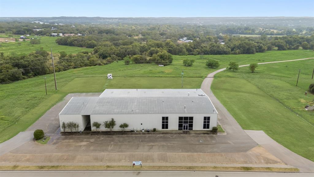 Prime Commercial Property with I-20 Frontage – Weatherford, TX
Outstanding commercial opportunity located directly on the I-20 service road in the heart of Weatherford’s rapidly growing commercial corridor. This high-visibility property sits on a 3.809-acre tract, with additional frontage land on both sides available for negotiation and soon to be listed.
The property boasts approximately 12,000 SF of warehouse and storage space with 20' ceilings and 12'x12' grade-level roll-up doors, ideal for accommodating large vehicles and logistics operations. 120,240 and 208 3 phase electric. Complementing the warehouse is approximately 9,000 SF of office, showroom, or flexible-use space, offering a versatile setup for a variety of business types. This is a rare opportunity to secure a high-exposure commercial site with flexible space and expansion potential in one of the fastest-growing areas of Parker County. Costco and the future site of Sprouts are located just across the highway. Building be sold AS-IS.