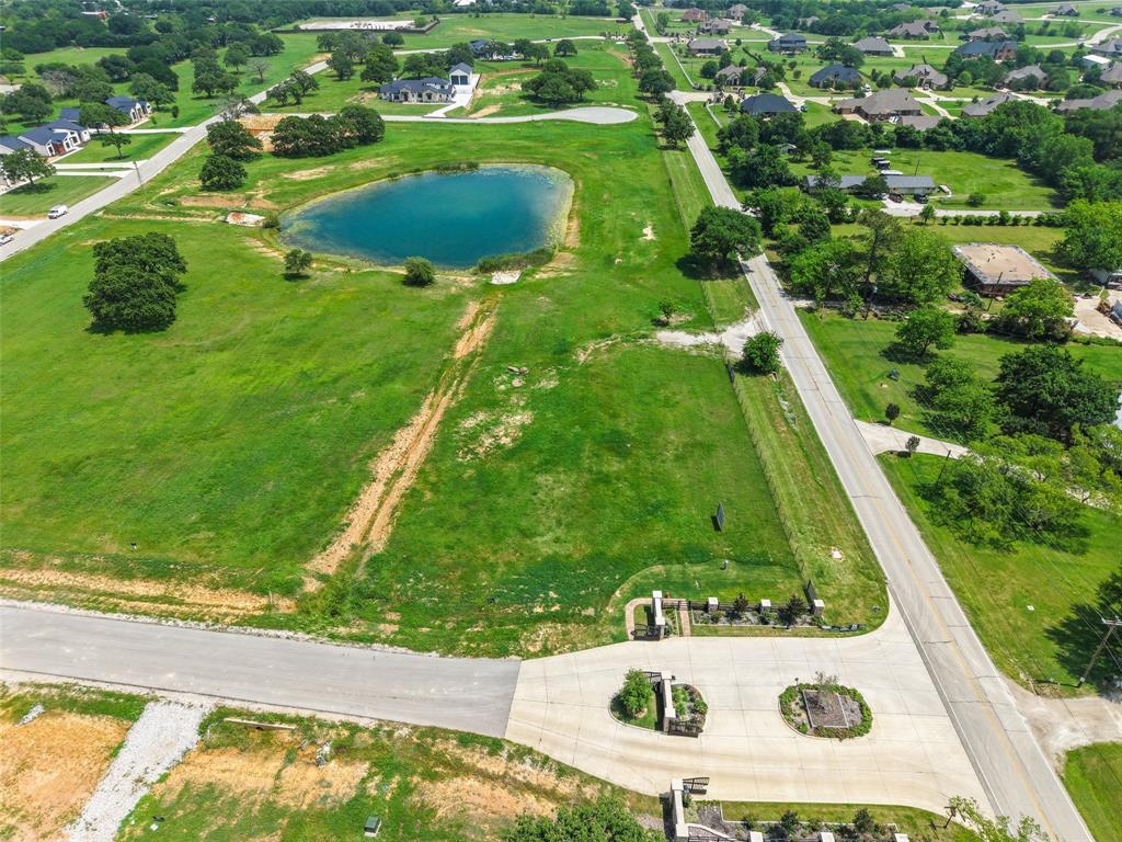 Build your dream estate on one of the most desirable homesites in Retta Oaks Ranch. Situated on a premier 1.65-acre corner lot with tranquil water views, this exceptional property offers the perfect blend of luxury, privacy, and natural beauty within an exclusive gated community. Surrounded by custom homes, mature trees, and estate-sized lots, the setting provides an ideal backdrop for a one-of-a-kind custom residence.

Located outside city limits and zoned to highly acclaimed Mansfield ISD, this homesite offers added flexibility while maintaining convenient access to shopping, dining, and major commuting routes. Community amenities include underground electric service, Bethesda water, a stocked pond, and architectural standards designed to preserve the neighborhood's upscale appeal and long-term value.

Bring your vision to life with Bedrock Homes LLC's full-service design-build program. Their experienced team can guide you through every step—from walking the lot and creating a personalized floor plan to constructing a custom home tailored to your lifestyle and preferences.

Rarely do corner lots with water views become available in this sought-after gated community. Don't miss the opportunity to create your custom luxury retreat in Retta Oaks Ranch.