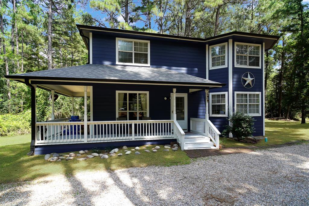 PEACEFUL COMFORT IN THE PINES - Discover this charming 2-story home boasting 2,237 sq ft, featuring 3 bedrooms and 3 full bathrooms, alongside 2 spacious living areas and an office or den. Nestled on a serene 0.8-acre forest lot, this property offers an ideal retreat with the perfect blend of privacy and community.  Set back from the road, the home enhances your sense of seclusion. A circular gravel driveway ensures easy access and ample parking for both family and guests. This expansive lot not only provides room to roam but also presents opportunities for potential additions or development.  The home has been thoughtfully updated, recently painted, and equipped with a newer roof and gutters, ensuring peace of mind for years to come. The first floor features charming ceramic tile floors, while the bedrooms are adorned with cozy carpeting. Designed with entertainment in mind, the layout encourages social gatherings downstairs, reserving the upstairs for restful sleep.  The modern kitchen, equipped with stainless steel appliances, serves as an inviting space for cooking and entertaining. Step outside onto the wrap-around front porch, a perfect setting to enjoy the outdoors and witness the frequent visits from roaming deer and vibrant birds.  With its natural landscape, yard maintenance is effortless, granting you more time to enjoy the amenities offered by Holly Lake Ranch. Engage in activities such as golf, tennis, pickleball, swimming, fishing, kayaking, and boating on the two large lakes. The community also offers putt-putt, frisbee golf, hiking, shooting, and access to the Holly Lake Fitness Center.  A membership at Holly Lake Ranch unlocks these world-class amenities and connects you with numerous social and recreational clubs, groups, and affiliations. Above all, the friendly neighbors and attentive services make Holly Lake Ranch a truly unique and welcoming experience. Embrace the peaceful comfort that awaits you in the pines!