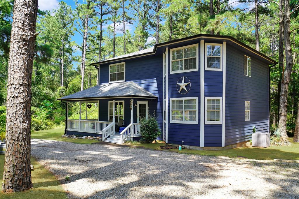 PEACEFUL COMFORT IN THE PINES - Discover this charming 2-story home boasting 2,237 sq ft, featuring 3 bedrooms and 3 full bathrooms, alongside 2 spacious living areas and an office or den. Nestled on a serene 0.8-acre forest lot, this property offers an ideal retreat with the perfect blend of privacy and community.  Set back from the road, the home enhances your sense of seclusion. A circular gravel driveway ensures easy access and ample parking for both family and guests. This expansive lot not only provides room to roam but also presents opportunities for potential additions or development.  The home has been thoughtfully updated, recently painted, and equipped with a newer roof and gutters, ensuring peace of mind for years to come. The first floor features charming ceramic tile floors, while the bedrooms are adorned with cozy carpeting. Designed with entertainment in mind, the layout encourages social gatherings downstairs, reserving the upstairs for restful sleep.  The modern kitchen, equipped with stainless steel appliances, serves as an inviting space for cooking and entertaining. Step outside onto the wrap-around front porch, a perfect setting to enjoy the outdoors and witness the frequent visits from roaming deer and vibrant birds.  With its natural landscape, yard maintenance is effortless, granting you more time to enjoy the amenities offered by Holly Lake Ranch. Engage in activities such as golf, tennis, pickleball, swimming, fishing, kayaking, and boating on the two large lakes. The community also offers putt-putt, frisbee golf, hiking, shooting, and access to the Holly Lake Fitness Center.  A membership at Holly Lake Ranch unlocks these world-class amenities and connects you with numerous social and recreational clubs, groups, and affiliations. Above all, the friendly neighbors and attentive services make Holly Lake Ranch a truly unique and welcoming experience. Embrace the peaceful comfort that awaits you in the pines!