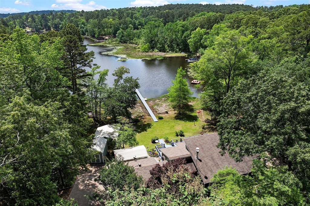 Looking for tranquility on the Lake???? Look no further!!!! This beautiful waterfront home is situated in the private Eagle
Landing subdivision and sits on 1 acre that is immaculately landscaped. This home boasts a beautiful open floor plan with a
custom fireplace and an oversized living area that steps into a fabulous sunroom filled with large windows for lake viewing all
through the year. It has 2 master en-suites that boasts beautiful tile flooring, walk in closets, oversized windows that are facing
the lake. The home has been reconstructed to accompany a large third bedroom and the bonus room could make a fourth
bedroom if needed. There is a chifforobe that will stay that could serve as closet space and for extra clothes storage, there is a
large customized cedar closet for extra storage inside the garage. The backyard features a deck with a covered patio beside it
for outdoor cooking and grilling. The storage building is wired with electricity and can be used to store yard equipment and is
large enough to be used as a workshop. There is a wonderful dock that has been freshly painted to fish off of or just sit and
enjoy watching the sunset. This home is perfect for entertaining guests with plenty of space inside and out! It is situated in just
the right spot for a gorgeous view of the lake and is a must see with all of its flexibility and spaciousness and has many
features that make it economical and keeps the utilities at a minimum! Don't wait, call today for your private showing!