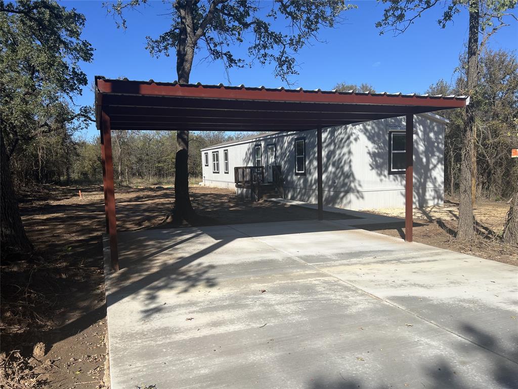 Brand new manufactured home tucked away in the quiet rural area of Runaway Bay. Step inside this beautiful home featuring 3 bedrooms and 2 full bathrooms. Master bedroom is secluded away from other bedrooms. Kitchen features an island, all matching whirlpool appliances including refrigerator, oven, microwave and dishwasher. Living room features a cozy electric fireplace with room for your large TV over the fireplace. 2 inch blinds on all windows. Owner has built a deck on the front and back as well as a paved parking pad with a carport and paved walkway to the front door.