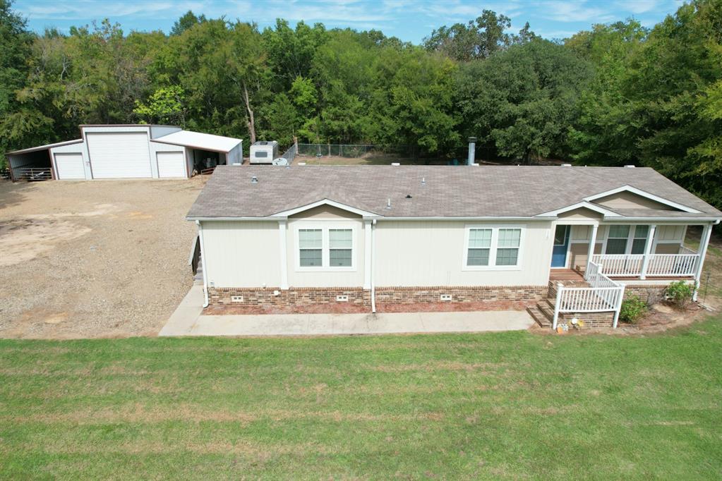 WALKING DISTANCE TO LAKE QUITMAN! Sitting on 3 lots, here is a 2015 high end home with 2x6 walls, tons of insulation and a great open floor plan that will work for the entire family! Home features 3 bedrooms; 2 bathrooms and an open kitchen,dining and living area with a wood burning fireplace. Huge master bedroom, large walk-in closet in the en-suite bathroom with a jetted tub and separate shower. Outside there is a 4x20 covered front porch, 14x28 covered back porch and a huge60x40 metal workshop building that's perfect for all your vehicles and toys! Fenced back yard to keep those pets and kids safe and is located in one of Lake Quitman's best neighborhoods. These rare finds are few and far between! Buyer to verify any and all information.