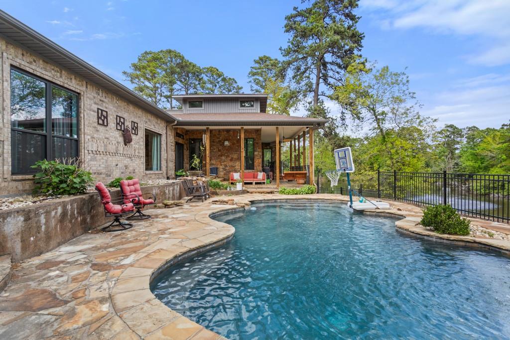 Don’t miss this rare opportunity to own a stunning estate on 3.3 acres with a private pond in Bullard, TX. Designed for exceptional indoor-outdoor living, this property offers resort-style amenities including a pool, hot tub, fire pit, and a private pond with fountain—perfect for fishing, kayaking, and relaxing evenings under the East Texas sky. Entertain with ease across multiple decks overlooking the picturesque landscape, creating the ultimate setting for gatherings both large and intimate. Inside, the home features 4 spacious bedrooms, 2.5 bathrooms, and thoughtfully curated designer finishes throughout. Expansive windows frame serene views of the outdoor oasis. The gourmet kitchen is a true centerpiece, equipped with abundant storage, a large island, ice machine, double ovens, and a gas cooktop—ideal for both everyday living and hosting. Located in the highly desirable Cumberland Ridge community, residents enjoy access to Lake Palestine amenities including a boat launch, picnic area, fishing pier, and convenient dry storage for boats and RVs. This is a rare blend of privacy, luxury, and lifestyle.