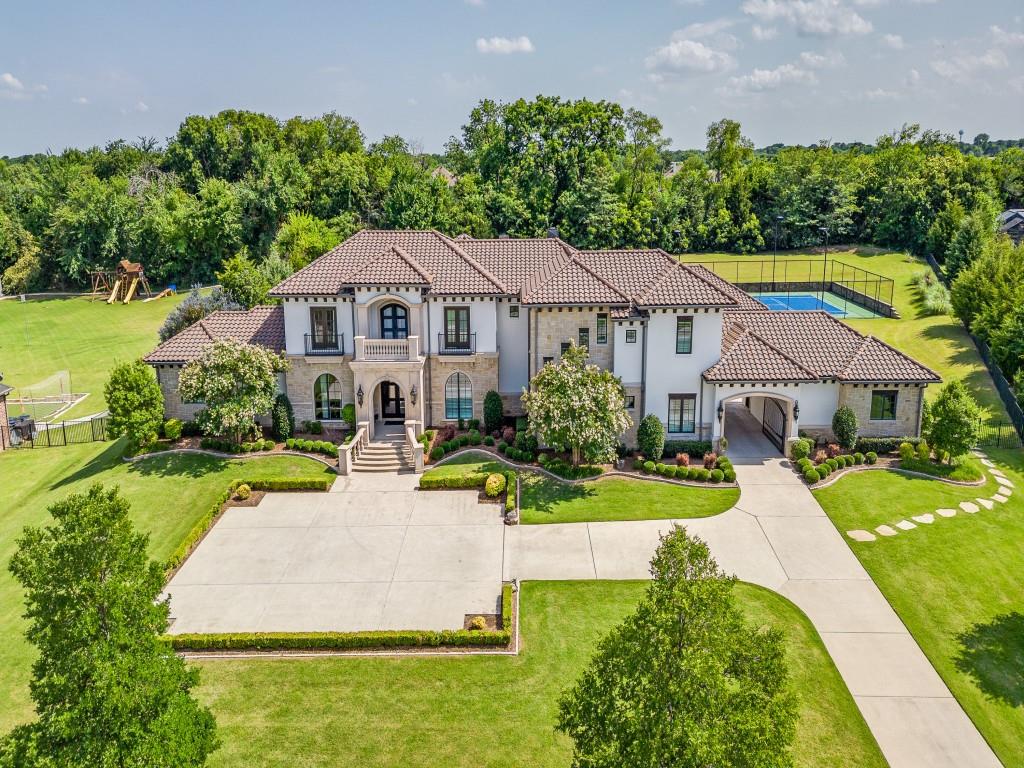 Major price improvement! Exquisite Entertainer's Estate on 2.1 Acre Tree Lined Lot. This estate is nestled on a tranquil cul-de-sac in a prestigious gated community offering privacy and serenity. Meticulously crafted with exceptional attention to detail, the home features extensive hardwood flooring with a stunning contemporary luxury design. Step into the grand foyer that leads to an elegant formal dining room, sweeping wrought iron staircase, and a cozy sitting area creating an inviting atmosphere. At the heart of the home lies a chef's dream kitchen-complete with quartz countertops, a Thermador refrigerator, Wolf appliances, two dishwashers, an entertainer's wet bar with a Sub-Zero, and large island with built-in table for casual dining. The kitchen flows seamlessly into the great room accented by wood beams, a striking floor-to-ceiling marble fireplace, and a wall of windows overlooking the backyard oasis. The private master suite is a true retreat with breathtaking pool views, private patio, dual vanities, a soaking tub, a walk-in double headed shower, updated flooring, and spacious closet with built-in safe room. Designed for entertaining this home also features a game room, an expansive wet bar and state-of-the-art media room. Continue upstairs to three bedrooms, three baths, loft and living area. Recent updates to multiple bathrooms and flooring. Step outside to your private resort-style back yard featuring an expansive pool with in-water table and bar stools, fire bowls, a water features and a spa. Entertain effortlessly in your outdoor living area with kitchen and fireplace. For the active lifestyle, enjoy an all-in-one lighted tennis, pickleball, and basketball court. Additional amenities include a 5 car garage with gated courtyard for added privacy and security. Ideally located minutes from premier shopping, dining and major highways. Zoned to LOVEJOY ISD. See Full List Of Updates In Transaction Desk.