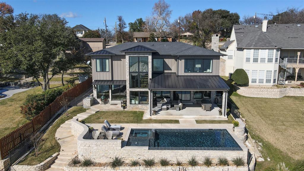Welcome to one of De Cordova Bend's most desirable streets. A 2018 tear down and rebuild of this unique lake property sits on the main body of Lake Granbury.  This entertaining gem features an open concept gourmet kitchen with Wolf-Subzero appliances for the discerning chef,  oversized windows across the entire lakeside of the living,kit,game room allow amazing views of the lake, a constant distraction.  Oversized Primary suite, ensuite bath, walk in closet, work out room, laundry, unobstructed views make it hard get up!  Ensuite guest and bunk rooms are comfortable areas for guests...they might not want to leave.  Zoned Trane HVAC to each room, foam insulation including attics, Anderson widows, to name a few of the many energy saving features throughout this vacation-primary residence lake home.  Gorgeous lakeside pool, hot tub, oversized climate controlled garage, new 3 slip aluminum covered dock,  are just a few more of the many features that make this residence a lake paradise.