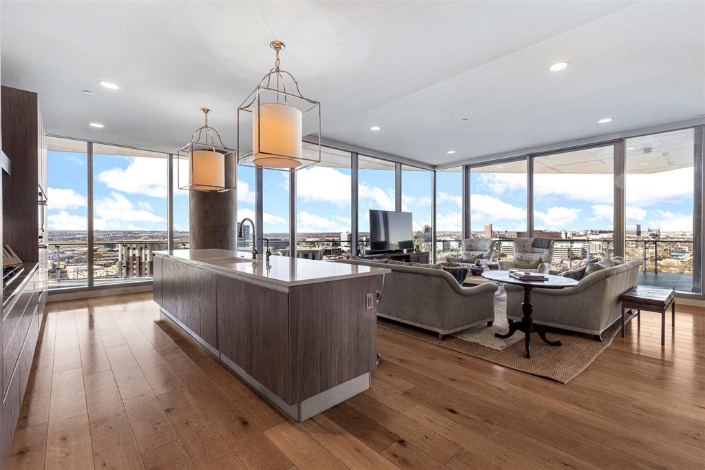 Experience modern sophistication in this exceptional residence located in the vibrant heart of the Harwood District in Uptown Dallas, masterfully designed by world-renowned French architect Jean-Michel Wilmotte. Ideally situated just minutes from the Park Cities, the American Airlines Center, and Love Field, the home is surrounded by the city’s finest dining, shopping, and nightlife.

This elegant three-bedroom, three-and-a-half-bath residence offers sweeping panoramic views of Dallas, showcased from two expansive private terraces—each appointed with a fireplace for year-round enjoyment.

Thoughtfully curated with elevated materials and designer finishes throughout, the home features marble and wood flooring, custom closets, and motorized shades for effortless living. The layout seamlessly blends form and function, offering a gracious living room, a gourmet chef’s kitchen, and a wet bar adjacent to the formal dining area—perfectly suited for both refined entertaining and everyday comfort.

Additional features include a walk-in pantry with refrigerated wine storage, two home offices and unparalleled views throughout the residence. The primary suite serves as a serene private retreat, complete with a spa-inspired bath and his and her walk in closets. Two guest bedrooms, each with en-suite baths, provide privacy and comfort for family and visitors alike. A rare benefit, the home comes with 2 two-car garages further enhancing the home’s exceptional offering.

Residents enjoy unmatched building amenities, including 24-hour valet and concierge services, car wash service, EV charging, and secure gated parking. Exclusive access is provided to a state-of-the-art spa, fitness center, yoga studio, two pools, wine cellar, social lounge, dog park, and direct access to the Katy Trail. Secure elevator access and a full-time professional staff complete this luxury living experience.