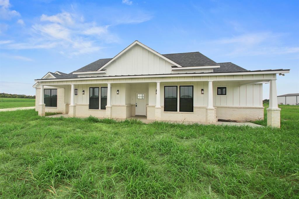 This brand-new, custom ranch-style home offers 3 bedrooms, an office, and a versatile flex room on 9.3 acres! Designed with thoughtful details throughout, the home features a spacious primary suite with a walk-in closet that includes washer and dryer hookups, along with a separate full laundry room on the opposite side of the house. The open layout was built with convenience in mind, including intentional outlet placement and flexible spaces to suit any lifestyle. Enjoy the expansive covered back patio for outdoor living and entertaining, all while surrounded by the beauty and privacy of country living in a timeless ranch-style elevation.