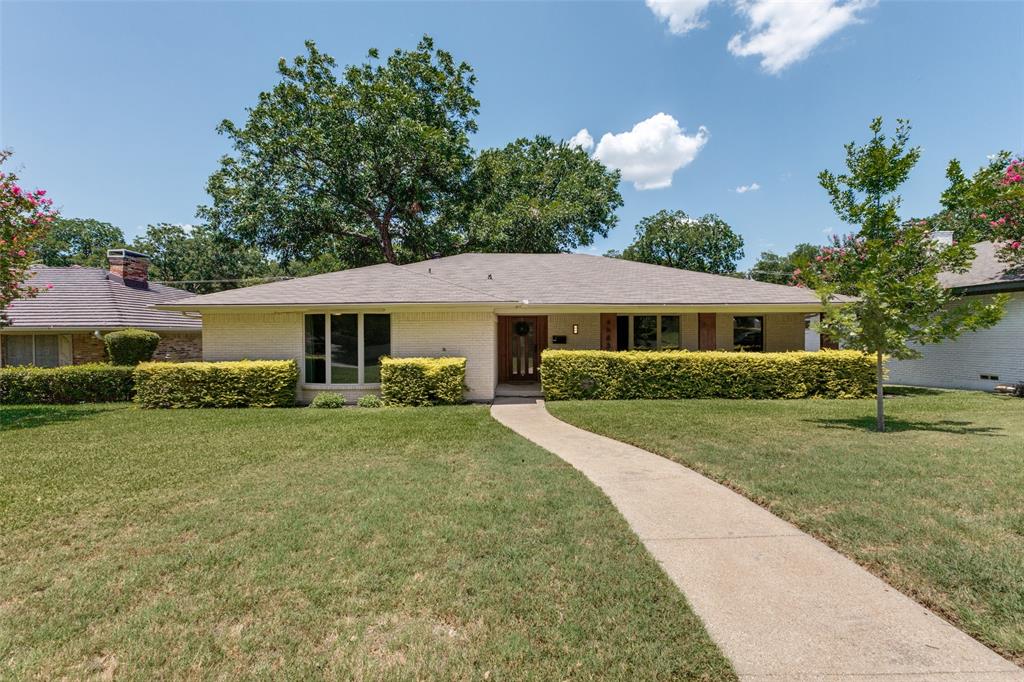 Located in the heart of Buckner Terrace, this thoughtfully updated 3 bedroom, 3 bathroom home with an office is surrounded by the mature trees, generous lot sizes, and established character that have made this neighborhood a Dallas favorite. Beautiful curb appeal and a large covered front porch create a warm welcome, while the flexible floor plan is designed for both everyday living and entertaining. Stacked formals with convenient access to the kitchen provide great flow for gatherings, while floor to ceiling picture windows fill the home with natural light. The spacious family room showcases a beamed ceiling, stone fireplace, and built in cabinetry. The kitchen offers double ovens, an electric cooktop, and abundant workspace, while the breakfast room includes a built in hutch that provides additional storage and serving space. The private primary suite features a tray ceiling and an updated ensuite bath with dual sinks, makeup vanity, and a large walk in shower with bench seating. Two secondary bedrooms share a full bathroom, while the office space includes its own full bathroom and offers flexibility for a home office, gym, or playroom. Outside, enjoy a spacious backyard with a board on board fence, mature shade tree, and open patio perfect for relaxing or entertaining. Conveniently located with easy access to Downtown Dallas, White Rock Lake, the Dallas Arboretum, Deep Ellum, shopping, dining, and major commuter routes. Known for its established landscape and neighborhood feel, Buckner Terrace offers a setting that is becoming increasingly difficult to find in Dallas.