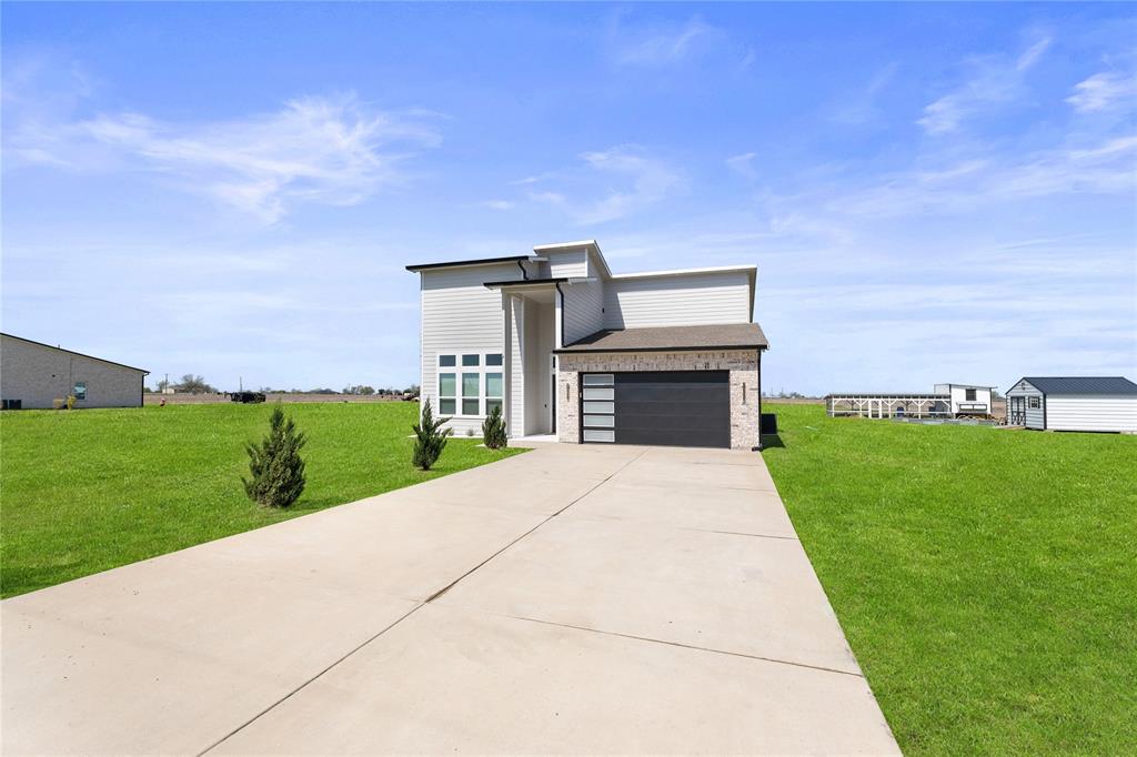 Welcome to this stunning modern home offering 4 spacious bedrooms, 2 beautifully designed bathrooms, and 2.32 scenic acres — complete with your own private pond for serene views and unforgettable sunsets. From the moment you arrive, you are greeted by the impressive curb appeal, 2-car garage, and expansive concrete driveway with plenty of space for guests. Step inside to soaring ceilings and an abundance of natural light that highlight the home’s open, airy layout. The heart of the home is a show-stopping kitchen featuring a massive 10-foot island, sleek quartz countertops, stainless steel appliances, abundant cabinetry, and a spacious pantry — perfect for entertaining or everyday living. The oversized living room provides ample space to gather and create lasting memories, while the dining area is ideal for hosting holidays and special occasions. Retreat to a luxurious primary suite designed for comfort and elegance, complete with double vanities, quartz countertops, designer lighting, a glass-enclosed shower with a built-in bench, and a generous walk-in closet. Enjoy the covered patio where you can relax and appreciate the peaceful surroundings.
This property offers the perfect blend of modern style, space, and privacy, all while keeping you close to city amenities.
