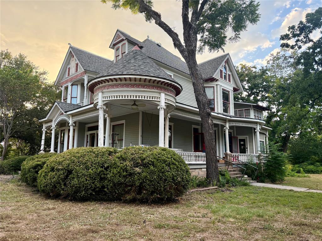 The Aston house, a beautiful piece of history, is a stunning waterfront property on a corner lot, just one block off the Granbury Historical Square, AND on nearly an acre! This is the rarest opportunity to hit the market in years. Stepping on to this iconic estate, you will be captivated by the extensive covered porches, original hardwoods, intricate millwork, stained glass windows and timeless architectural details and immediately be overwhelmed with the endless possibilities whether you dream of restoring a grand private residence or creating an extraordinary bed and breakfast. The thoughtful details of the past just need a restorative vision to bring this home back to its glory. Stepping out back, you will find an extensive tree lined clearing that offers a sense of privacy and serenity right in the heart of Granbury. This is a legacy waiting for its next chapter.