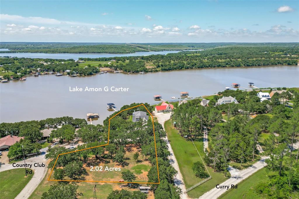 This custom-built lake house sits directly on the water at Lake Amon G. Carter, offering unobstructed views, quiet mornings, and sunsets that never get old. Just over an hour from Fort Worth and an easy drive from Dallas, it feels private and removed without being inconvenient. 

Completed in 2022, the home blends clean architectural lines with a relaxed lake-house sensibility. From the moment you enter, the water becomes the focal point. Expansive windows frame the view and fill the living spaces with natural light. The open layout was designed for gathering - long weekends with family, shared meals with friends, or quiet evenings overlooking the lake. The kitchen anchors the main living area with generous workspace and a substantial island that naturally becomes the center of conversation. The primary suite offers lake views and a peaceful retreat, while two additional bedrooms, each with a private ensuite bath, provide comfort and privacy for guests. This home was thoughtfully designed, creating the opportunity to reconfigure and add additional bedrooms or living space in the open attic space. 

 
Step outside and you’re immediately in lake mode. Covered outdoor living overlooks the water, complete with a fireplace and space to unwind year-round. A lower patio near the shoreline, private beach, and custom dock with lift make time on the water effortless. Set on two private acres, the property offers space, calm, and privacy - a rare combination on the water. The acreage also provides room for a future guest home, workshop, or additional outbuilding, subject to approvals. Every detail was thoughtfully considered during construction, resulting in a home that feels solid, timeless, and built to endure. If you’ve been looking for a place where life slows down and weekends stretch a little longer,
this is it.