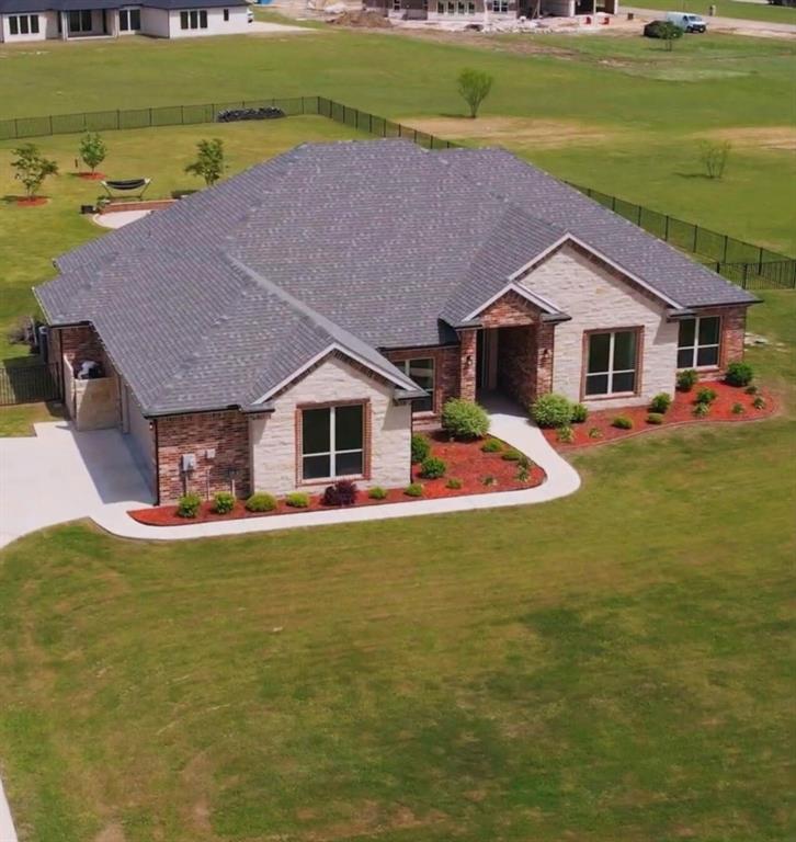 Beautiful custom brick home tucked away on a cul-de-sac in Shadow Lakes, situated on just over an acre with a fenced backyard. This home offers the perfect blend of warmth, space, and functionality.  With 4 bedrooms, 3 full baths, and a spacious bonus room that could easily serve as a 5th bedroom, there’s room for everyone to live, work, and gather. The open layout is filled with natural light and complemented by excellent storage throughout.  The kitchen features a large island, generous cabinetry, and a dry bar that could easily be converted into a mudroom or beverage station. The primary suite offers a spa-like bath and a spacious walk-in closet for effortless organization.  A split-bedroom layout provides privacy and flexibility, ideal for guests or multi-generational living. One bedroom includes its own private bath and walk-in closet, while the fourth bedroom—currently set up as a home gym—could easily serve as a multipurpose room. An additional office at the front of the home adds even more flexibility for work-from-home or study space.  Step outside to a cozy backyard retreat with a firepit, perfect for cool evenings and entertaining. Residents enjoy Shadow Lakes amenities including walking trails, a stocked fishing lake, playground, and community pool.