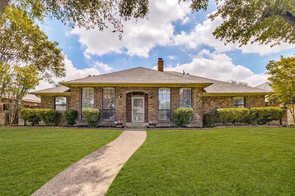Welcome to this well-maintained single-story home with mature trees in the established Whispering Hills neighborhood, zoned to Richardson ISD. Offering 4 bedrooms, 2.5 baths, and a functional floor plan, this home combines classic features with recent updates. Interior features include marble tile flooring, crown molding, custom millwork, built-in cabinetry and multiple living and dining areas. Recent updates include fresh interior paint, updated ceiling fans, blinds throughout, and an updated dining room light fixture. The kitchen offers painted cabinetry, granite countertops, a recently installed 5-burner gas cooktop, vent hood, dishwasher, updated faucets, and ample cabinet storage. The spacious dining and family rooms provide comfortable gathering spaces, featuring a gas brick fireplace, built-in bar, and large windows for natural light. The primary suite includes dual vanities, a soaking tub, walk-in shower, and separate dual closets. The solarium overlooks the backyard and offers flexible space for a home office, exercise room, sitting area, or hobby space. Additional updates include a roof replaced approximately two years ago and a 2023 Rheem water heater. The garage features epoxy-coated floors and built-in storage shelving. No HOA. Convenient Northeast Dallas location near shopping, restaurants, parks, major highways, NorthPark Center, Richland College, and easy access to nearby elementary and junior high campuses.
