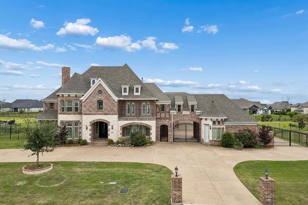Welcome to this extraordinary estate on a one-acre lot in Parkers prestigious Whitestone Estates. This 8,525-square-foot showpiece has been elevated with significant owner upgrades that set it apart from anything else on the market. Arrive to a wide circular drive leading to double iron front doors that open to a breathtaking two-story entry flanked by dual curved staircases. The grand family room beyond features soaring vaulted ceilings, a floor-to-ceiling stacked stone fireplace, and stunning curved balconies looking down from above. The chefs kitchen is equally commanding anchored by a stunning 9x9 foot granite island, dual dishwashers, 48-inch Jenn-Air professional range, glass-front lighted cabinetry, and 9x7 walk in pantry. A distinctive feature is its rare dual master suite layout, ideal for multi-generational living. The main level primary bed offers a spa bath and large closet with designer customized closet system and convenient washer and dryer. The second full master upstairs mirrors that luxury with its own sitting area, bath, customized closet and laundry access. A dedicated office, large dining, formal living room and guest bedroom round out the first floor. A game room and media offer additional entertaining up. Two bedrooms connected by a loft with dual built-in desks is great for studying. A separate bedroom completes the upstairs that anticipates every need. Every bedroom has an ensuite bath and two laundry rooms, one per level, add everyday practicality to the luxury experience. Owner upgrades include a home theater, hardwood flooring throughout the upper level, a whole house water filtration system, EV charger, custom closet systems, security cameras and solar panels to dramatically reduces energy costs. A significant advantage in a home of this scale. With a four-car garage, Plano ISD schools, one acre lot, and a floor plan that lives as beautifully as it photographs, 5008 Kingston Court is one of the most compelling luxury offerings in Parker.