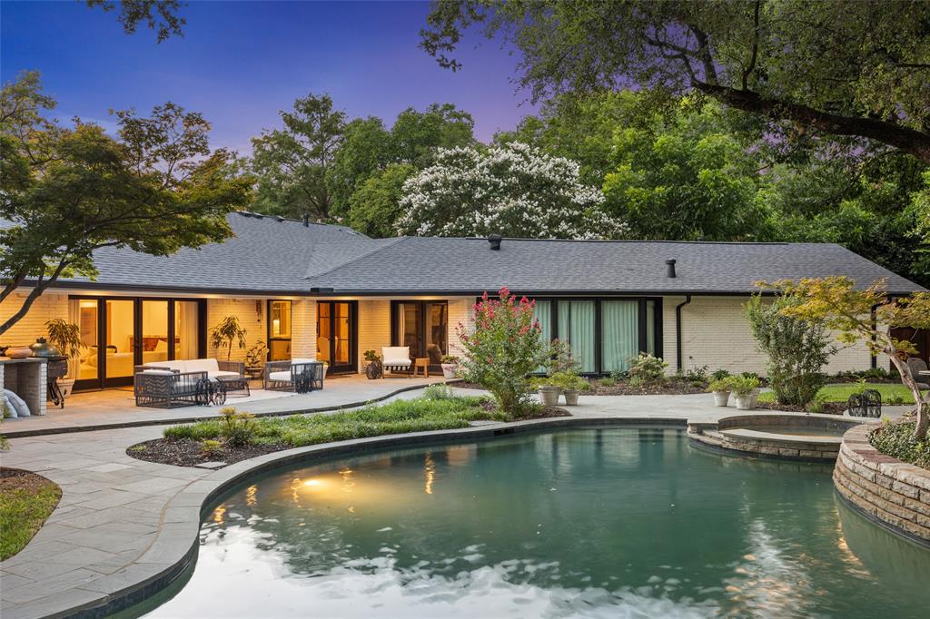 A collection of spaces that blends luxury, creativity, and comfort, offering unforgettable experiences. Situated on .55 acres, this single-story, professionally designed residence has been featured in magazines. The kitchen boasts a 10-foot ceiling, Thermador Professional Collection appliances, bespoke rift-sawn oak cabinetry, and Calacatta Michelangelo marble countertops and island. The living area features an original rock fireplace wall with a terrazzo hearth and views of the renovated pool, stone decking, and lush landscaping. A wine showcase room complements the boutique wet bar includes intimate seating, a waterfall counter, premium spirit display shelves, an integrated ice maker, and a beverage fridge. The best views of the pool from the oversized primary suite featuring a spa bath retreat, his her walk-in closets, a home office, and a gym. Located in a fantastic neighborhood near prestigious private schools, custom-made and curated furniture is available for purchase separately