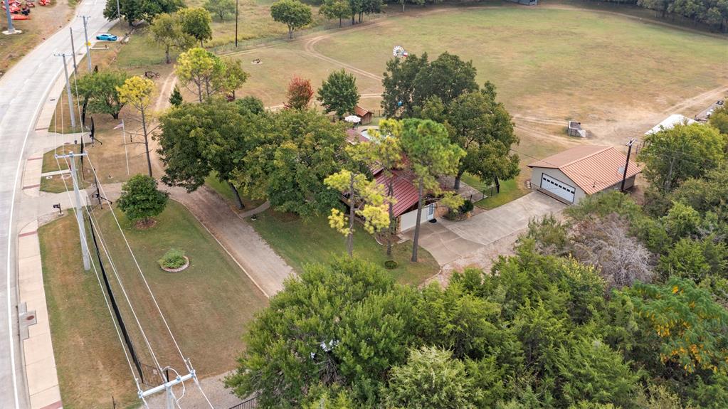 Discover this breathtaking 5.9-acre estate located on East Bound Frontage Road in Grand Prairie. The home, a beautifully remodeled 2,350 sq ft old Chicago brick residence, was built in 1966 and offers 5 bedrooms and 3 baths. It features an open-concept living area with bamboo floors, granite countertops, and a wood-burning fireplace, all framed by panoramic views of the pasture and Fish Creek.

The property has no carpet, high-speed fiber internet, dual-pane windows, and a new metal roof. Outside, you'll find a heated pool and hot tub, a detached 4-car garage, a barn, and a tractor shed. The land is fenced at the road with wrought iron fencing and a gate and features a private well, lush landscaping, and mature pecan trees. Enjoy the perfect blend of country living with the convenience of being just minutes from DFW Airport, Dallas, and Fort Worth. This estate is an ideal retreat with endless possibilities. You can make this homestead and sit on it for future investment opportunities OR bring your home based business here for the ultimate live-work experience!