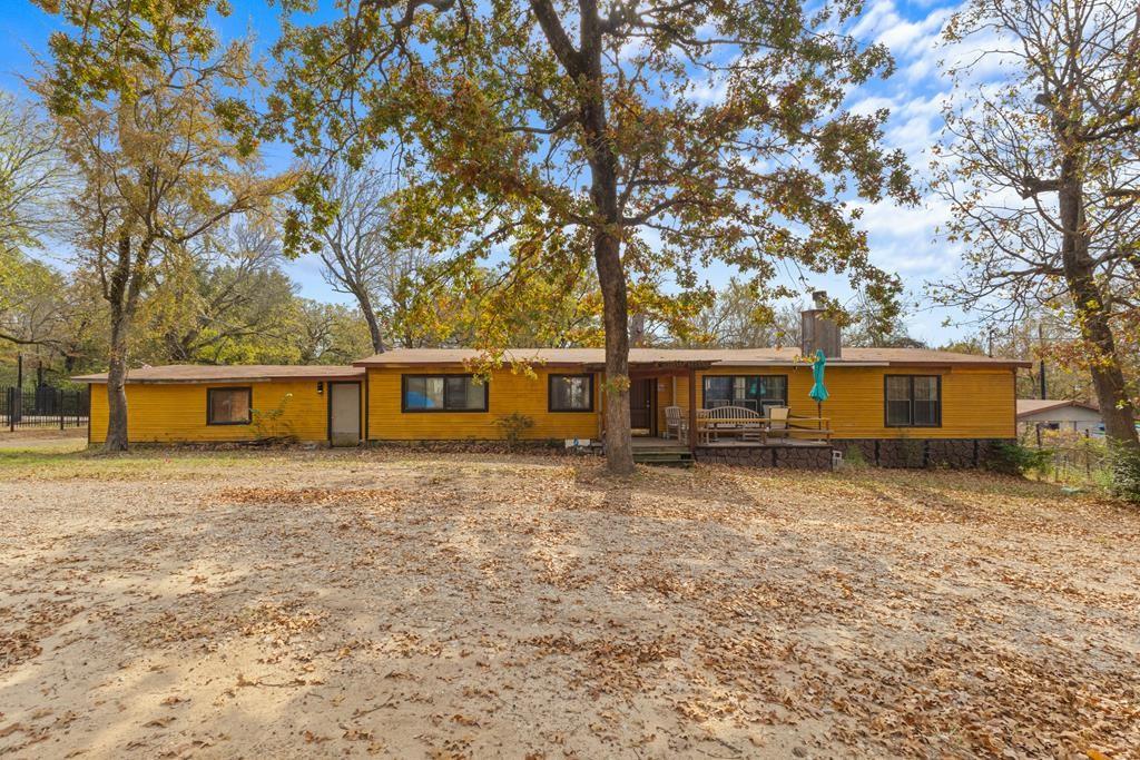 Welcome to this beautifully updated, move-in-ready double-wide home featuring a custom add-on and a welcoming front porch with a cozy sitting area. Offering 3 bedrooms, 2 bathrooms, and a versatile bonus room that can serve as a 4th bedroom, office, or hobby space, this property provides exceptional flexibility for a variety of needs.

The expansive add-on is perfect as a game room, entertainment area, or oversized family room—ideal for gatherings, movie nights, or hosting guests. With approximately 2,900 sq ft of living space, this home showcases numerous recent upgrades, including new flooring, new siding, beadboard ceilings, and a charming fireplace.

The kitchen features a large walk-in pantry, while the spacious utility room adds convenience and extra storage. A tankless water heater ensures energy efficiency and endless hot water. The home comes fully furnished and includes the washer, dryer, two refrigerators, and a microwave—creating a truly turnkey opportunity.

Outside, enjoy a large fenced backyard, perfect for pets, outdoor living, and family fun, along with a gazebo for relaxing or entertaining. A detached garage provides excellent storage and is ideally suited for parking a boat or additional vehicles. With an acceptable offer, the pontoon boat will convey, offering outstanding value for those who enjoy lake life. This property also offers a beautiful lake view and is just minutes from launching your boat at Cherokee Landing, providing quick and easy access to the water.

This well-maintained property offers generous space, thoughtful updates, and unique extras rarely found at this price point. Schedule your showing today!
