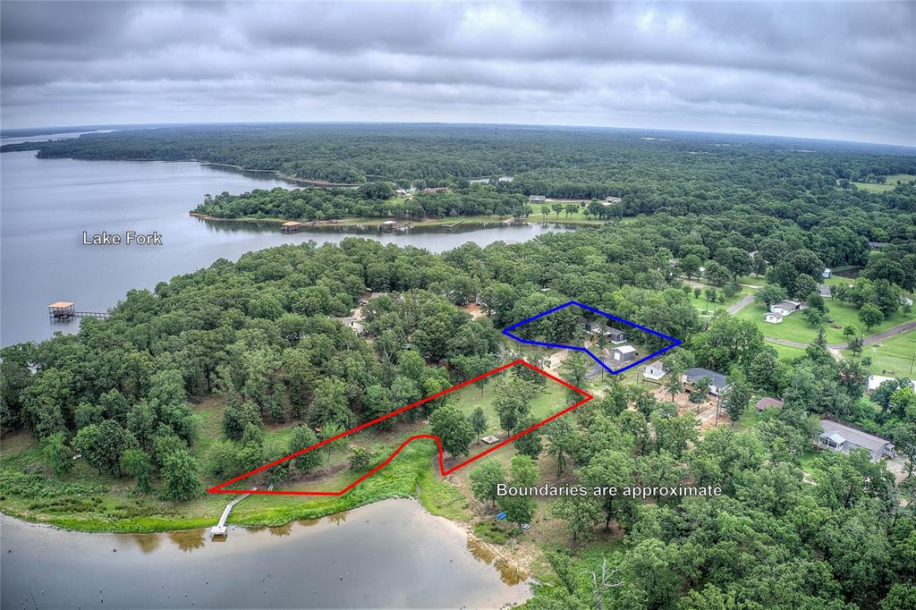 Waterfront on Lake Fork! THREE lots! Private fishing pier and dock!  2023 Manufactured home in highly-sought-after Holiday Villages; shows like new, 1191 sf, 3 bed 2 bath, with open kitchen including large island with breakfast bar, farmhouse-style stainless steel sink, generous living room. Primary suite has garden tub and separate shower with dual sinks and walk-in closet. Split-bedroom layout for privacy, bedrooms 2&3 share a hall bath. Separate laundry room has room for freezer. Maintenance-free LVP floors throughout. AMAZING water views from your covered front porch.

Steps away is a detached metal garage or workshop, 20x18, 10 foot high ceiling, and an 8x8 roll-up door, perfect for boat storage or as a workshop. Then walk down onto your 0.68 Ac of SRA land, and out onto your own fishing pier with dock! 133 linear feet of shoreline for you to enjoy, with sole rights and usage. POA is $52 a month, and provides access to fishing ponds, boat ramp, tennis courts, basketball courts, laundry, and club house. 100 miles to DFW. 

Lake Fork is one of the 10 largest lakes in Texas and is the #1 Bass fishing lake in the U.S. according to Bassmasters 2021 rankings. Nestled in between I-30 and I-20, it is located 65 miles east of Dallas and 40 miles north of Tyler. Its 315 miles of shoreline stretch from Quitman and Alba to Emory and Yantis and occupies 27,690 acres. Established in 1979, the reservoir is a premier bass fishing lake holding 34 out of the Top 50 and 15 of the top 20 Texas State Record Largemouth Bass. Other species of fish include catfish, black and white crappie, sunfish, and bluegill. Lake Fork offers many forms of recreation: golf courses, resorts, fishing tournaments, boat tours, restaurants, marinas, and camping. The nearby towns of Sulphur Springs, Winnsboro and Mineola have great downtown areas that include boutique shopping, wonderful restaurants, festivals, live music, farmer’s markets, and more!