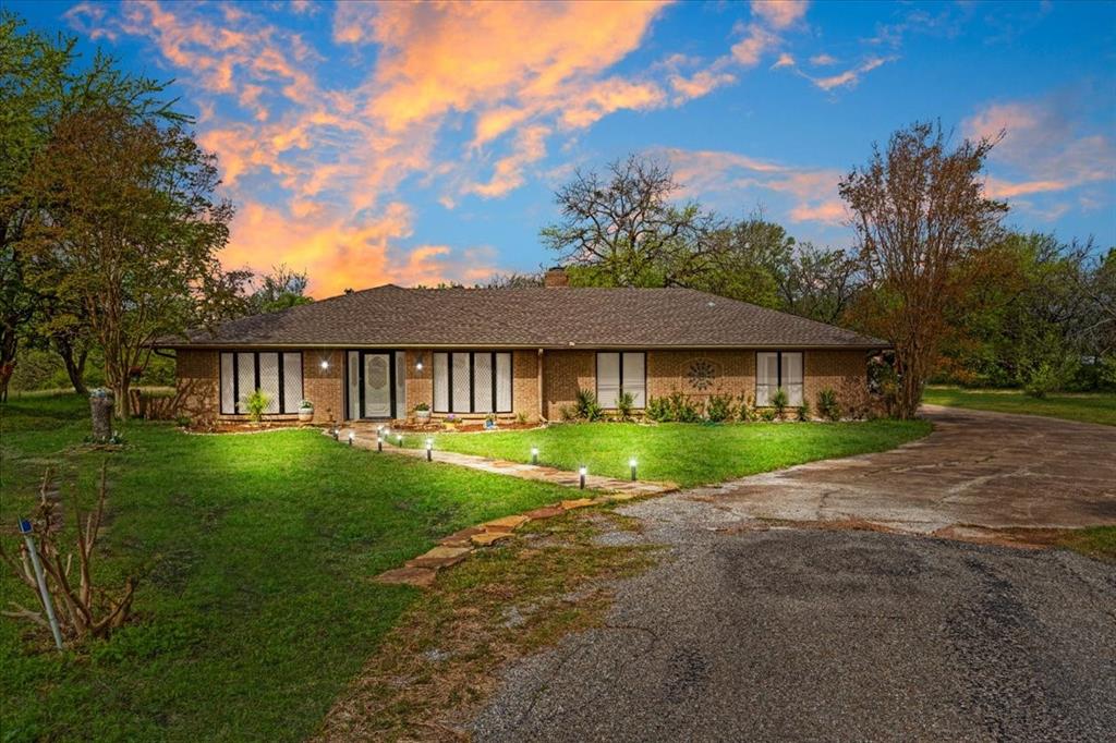 Ideal for today’s remote and hybrid professionals, this private 3.95± acre property offers the perfect combination of dedicated work-from-home functionality, peaceful country living, and convenient access to major employment hubs. Located within approximately 15 minutes of major technology organizations, including Texas Instruments, this property is perfectly positioned for professionals seeking space, privacy, and a manageable commute to Sherman and the greater Dallas metro area.

Inside the spacious 2,446± square foot brick home, you’ll find four bedrooms, three full bathrooms, formal living and dining areas, and a dedicated office space ideal for remote work, virtual meetings, studying, or operating a home-based business. Whether you work fully remote or commute into Dallas part-time, this home provides the flexibility and comfort today’s buyers are searching for. A cozy fireplace adds warmth and charm to the main living area, while the versatile lanai offers additional options for a second workspace, media room, home gym, or expanded living area.

Thoughtfully positioned on the acreage with approximately one acre of separation from the nearest neighbor, the property creates a quiet, productive environment perfect for focused work and relaxed living. Mature trees, established fruit trees—including plum, pear, and two peach trees—mature rose bushes, and a productive asparagus patch add beauty and functionality to the outdoor space.

Additionally, the property features an RV building with electricity and lighting, a workshop, multiple storage sheds, and a chicken coop, providing endless flexibility for hobbies, equipment, storage, or recreational use. The fenced backyard is ideal for pets and outdoor enjoyment.

If you’ve been searching for a property that supports your work-from-home lifestyle without sacrificing access to major tech employers and the Dallas metroplex, this is the opportunity you’ve been waiting for. Schedule your showing today!