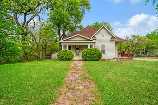 Oh the charm of this circa 1950's gem!  Bring your vision and design talents to this spacious home and make it grand again.  Located on large corner lot, and sitting back off the street, this home has so much potential.  Formal living room with older, non-operating fireplace features wood flooring, has been used as a bedroom in the past.  Over-sized dining room intended to house even the most prestigious of dining accessories.  The family den or primary living space has bay window, fireplace and plenty of space for entertaining.  Open kitchen with adjoining breakfast space ready for a make-over. 2 bedrooms share a Jack and Jill bath.  Outside is a detached 2 car garage with shop-storage area.   A lot of square feet waiting for someone to love and restore. House had plumbing updated in 2024, Central HVAC installed 2010.  Extra insulation added in recent years.   Upstairs is an attic.