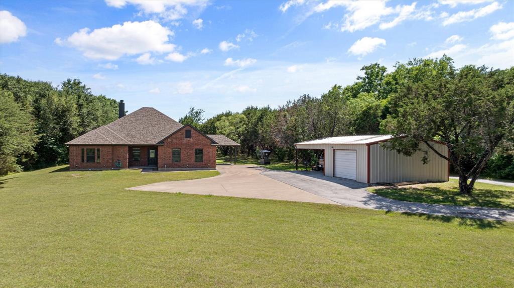 Enjoy country living close to town! This beautiful home features 4 bedrooms, 2 bathrooms, 2 living areas, and a workshop on 7.8 acres.  This secluded custom home has a large family room and an open floor plan.  Home has a fresh coat of paint throughout the entire home.  Plantation shutters, neutral paint color and lots of natural light. The gorgeous engineered hardwood floors are throughout the entire house.  The all electric kitchen boasts granite countertops, a nice pantry and an island for extra workspace.  Master bathroom has a separate tub and shower, his-and-her walk-in closets, and a double vanity.  Bonus room could be used as a second living room, an additional bedroom, a game room, a playroom for the kids, craft space, or a man-cave, the possibilities are endless.  The backyard is fenced around the house for pets.  Metal workshop is detached and has electricity, is insulated and could be used as a garage, workshop or huge storage area; it also has an attached carport.  The land has areas with many trees, and other areas are open and ready for your use, including for horses.  There is also a seasonal creek.  No HOA.  Come check out this great house on an awesome, quiet piece of land just minutes from shopping, dining and all the great things Granbury has to offer.