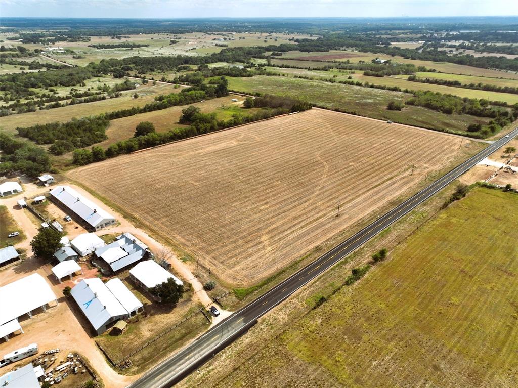 Prime Round Top location on Hwy 237 (approx. 1095 feet road frontage) on the corner of Leonhardt Rd (approx. 690 feet road frontage.) Level, open land ready to develop. Approx. 2.5 miles from Round Top Town Square and next to and across from major antique show venues. See attached aerial.