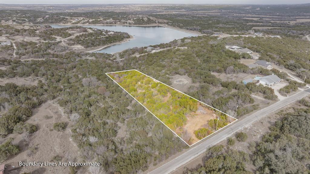 Beautiful 3-acre property located in the heart of Mountain Lakes Ranch. Partially cleared at the front, offering an ideal building site while maintaining privacy and natural surroundings. Conveniently located close to all subdivision amenities, making this a great opportunity to enjoy both space and community living. Water and electricity available at the front of the lot. No build time requirement and a 1,400 sq. ft. minimum living space. Annual assessment is just 295. Located in Bluff Dale, Texas—perfectly situated on Hwy 377 between the Cowboy Capital of the World, Stephenville, and the historic town of Granbury. Come experience breathtaking Texas sunsets, star-filled skies, and abundant wildlife. Mountain Lakes amenities include a recreational lake, fishing lake, clubhouse, pool, park, walking path, garden, and RV park—country living at its finest!