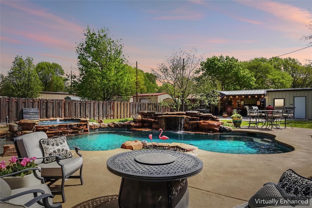 If you love to both entertain and be entertained, this home is for you! This open concept great room allows for card games in front of the bay window, casual conversation seated at the fireplace, informal grazing at the kitchen bar and formal dining next to the butler's pantry. Many updates to this classic home were made in 2018, including porcelain flooring, custom cabinets, granite countertops, and last but not least, the pool! The 20,000 gal pool with waterfall, can be heated from the hot tub and has a custom volleyball net. There are not one, but two outdoor bar areas for serving. The man cave has coverage from the weather, storage, wood burning stove, instant hot water and a bathroom. Additional highlights of this top notch property include a 2 car full size garage, detached 1 car garage with covered parking(would double as an insulated workshop) and a private well servicing the sprinklers and mancave. Situated on a spacious half acre lot in the heart of Muenster, Texas, renowned for it's strong community, excellent schools, and rich German heritage.  The decision to move to Maple Street is easy with options like this! Information deemed reliable but to be verified by buyer and agent.