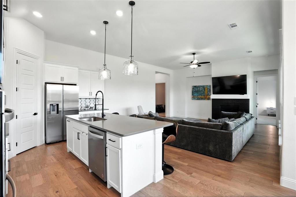 FULLY FURNISHED and beautifully upgraded, this exceptional 4-bedroom, 4-bath home offers flexible living space, designer finishes, and a premium lot with no rear neighbors, backing to a peaceful pocket park for added privacy. Ideal for relocation buyers, corporate moves, or anyone seeking a true turnkey experience, this move-in-ready home combines comfort, style, and convenience.

Inside, you’ll find hardwood floors, soaring ceilings, oversized windows, and abundant natural light throughout. The open-concept living area features a sleek fireplace, wood-beamed ceilings, and custom accent walls that create a warm yet modern feel. An upgraded glass-panel front door and matte black hardware add a refined touch throughout the home.

The chef’s kitchen includes quartz countertops, stainless steel appliances, designer backsplash, ample cabinetry, and a spacious walk-in pantry. The kitchen flows seamlessly into the dining and living areas, making it ideal for entertaining. A private study with glass French doors provides a dedicated work-from-home space, while the media room offers flexibility for movie nights, gaming, or additional living space.

The spacious primary suite features upgraded carpet and premium padding, along with a spa-inspired bath complete with a frameless glass shower, garden tub, dual vanities, and large walk-in closet. A secondary bedroom with private ensuite bath is ideal for guests or multigenerational living.

Additional features include a mudroom, 3-car garage, and included furnishings for an easy transition into your new home. Located in the highly desirable Sandbrock Ranch community with fitness center, dog parks, playgrounds, walking trails, community events, and an on-site elementary school.

Conveniently located minutes from Frisco, Costco, H-E-B, and the upcoming Universal Kids Resort, this home offers the perfect blend of location, lifestyle, and move-in-ready convenience.