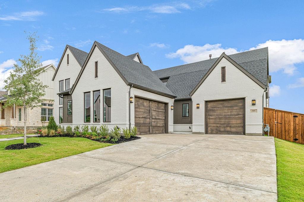 $20,000 CONCESSIONS AVAILABLE WITH ACCEPTABLE OFFER. OVER $100,000 IN SAVINGS ALREADY. Built by Toll Brothers, this turnkey Valerie Tudor home design. Located in the highly desirable Wandering Creek at Brookhollow community and zoned to Walnut Grove High School, this home offers a perfect balance of luxury, convenience, and lifestyle. Enjoy scenic surroundings with easy access to top-rated schools, dining, and entertainment, along with close proximity to PGA Frisco, Universal Studios Kids Resort, and Gates of Prosper. Additional features include a smart home system, a prewired media room with Dolby Atmos, and a well appointed outdoor living space.
A private courtyard just off the staircase fills the home with natural light and creates an additional outdoor retreat, perfect for relaxing or entertaining.
The chef’s kitchen is thoughtfully designed with Taj Mahal quartzite countertops, a waterfall island, full height backsplash, ceiling height cabinetry, JennAir appliances, a Wolf cooktop, and a Kohler farmhouse sink offering both style and functionality with ample storage.
Welcome Home!